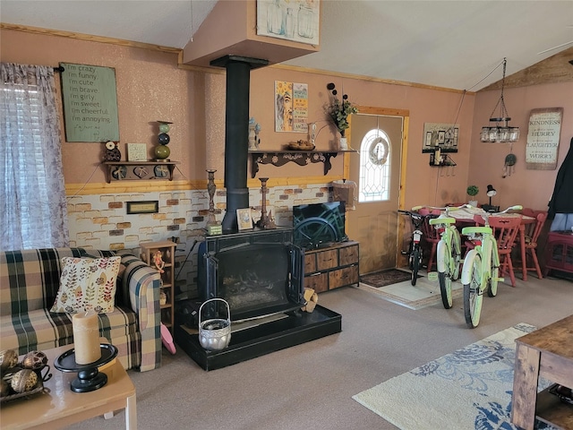 carpeted living room with vaulted ceiling and a wood stove