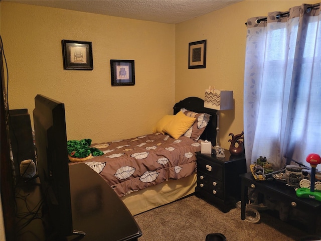 bedroom featuring a textured ceiling and carpet