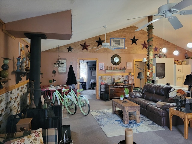 living room featuring lofted ceiling, ceiling fan, and a wood stove