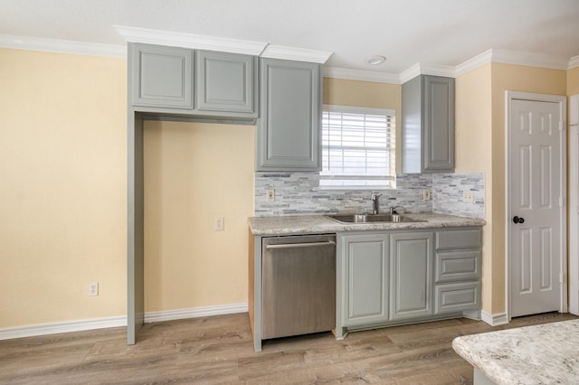 kitchen featuring dishwasher, light countertops, a sink, and light wood-style flooring