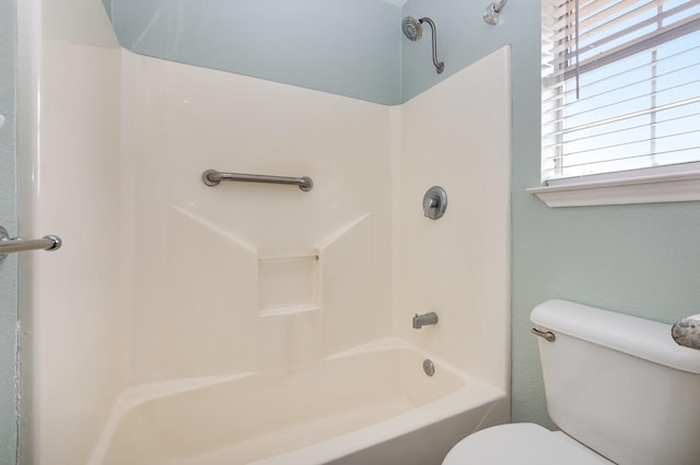 bathroom with shower / bathing tub combination and toilet