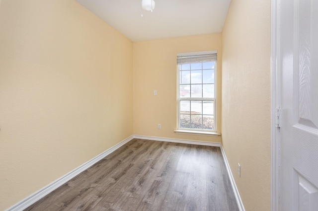 empty room with light wood-style flooring and baseboards