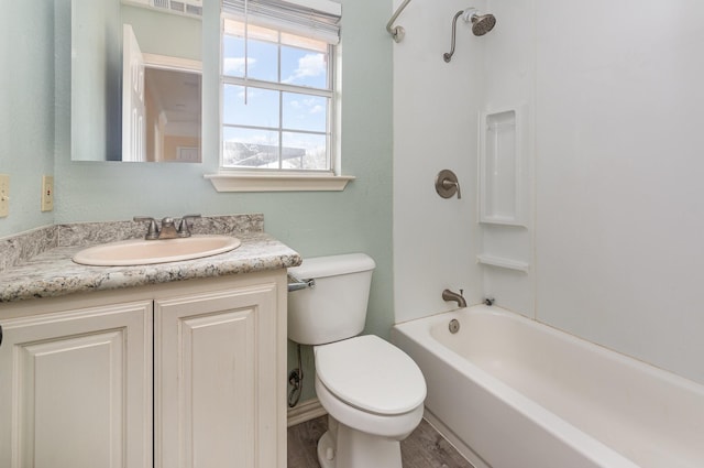 bathroom featuring vanity, toilet, and bathing tub / shower combination