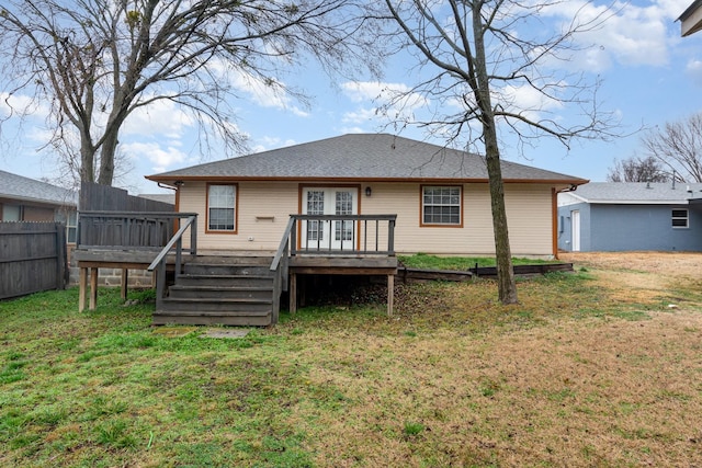 rear view of house with stairs, a yard, a wooden deck, and fence