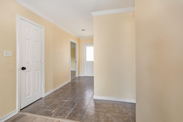 corridor featuring baseboards and crown molding