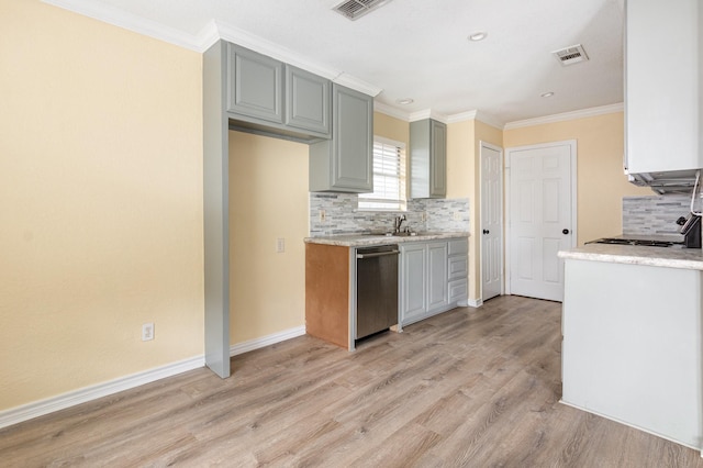 kitchen with light wood-style floors, light countertops, dishwasher, and visible vents