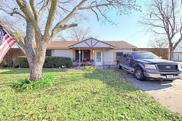 ranch-style home featuring a front yard