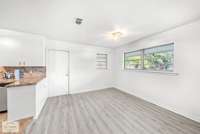 kitchen featuring backsplash, dishwasher, light hardwood / wood-style flooring, and white cabinets