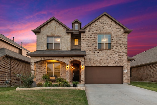 view of front of home featuring a yard and a garage