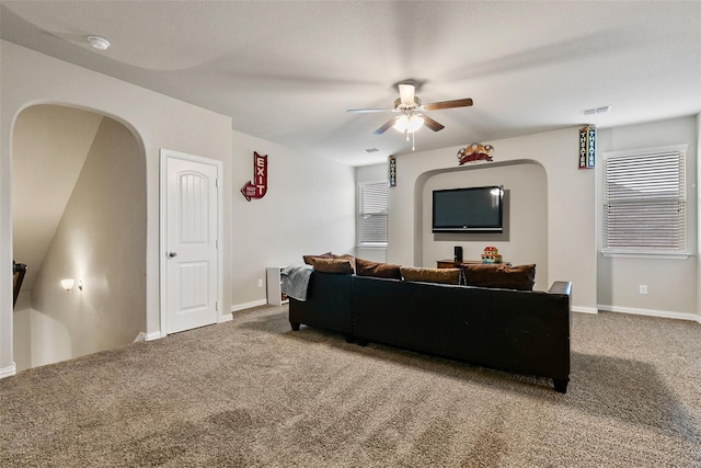 carpeted living room with ceiling fan