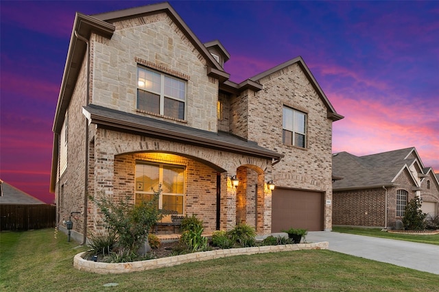 view of front of property with a lawn and a garage