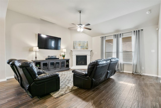 living room with hardwood / wood-style flooring, ceiling fan, and vaulted ceiling