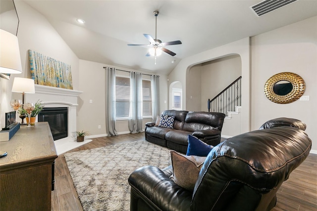 living room with wood-type flooring, lofted ceiling, and ceiling fan