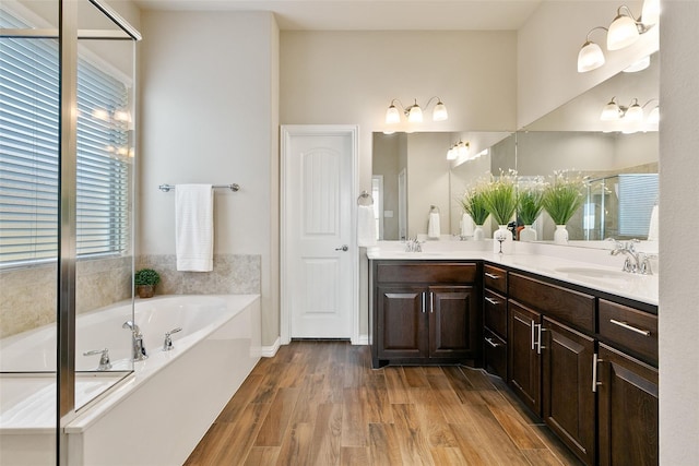 bathroom featuring vanity, a bathing tub, and hardwood / wood-style floors