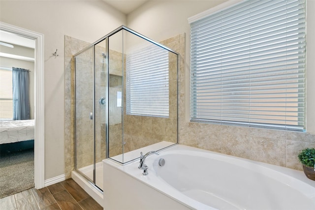 bathroom with a wealth of natural light and independent shower and bath