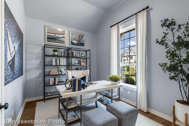 home office with hardwood / wood-style flooring, vaulted ceiling, and a wealth of natural light