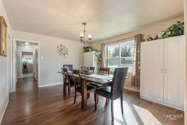 dining room featuring a notable chandelier and dark hardwood / wood-style floors