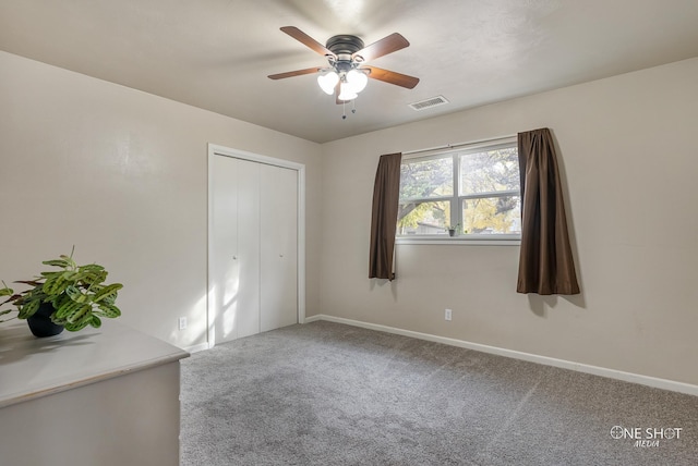 carpeted empty room with ceiling fan