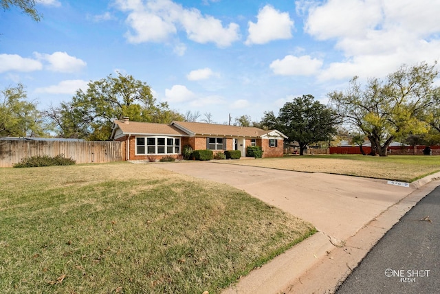 ranch-style home with a front lawn