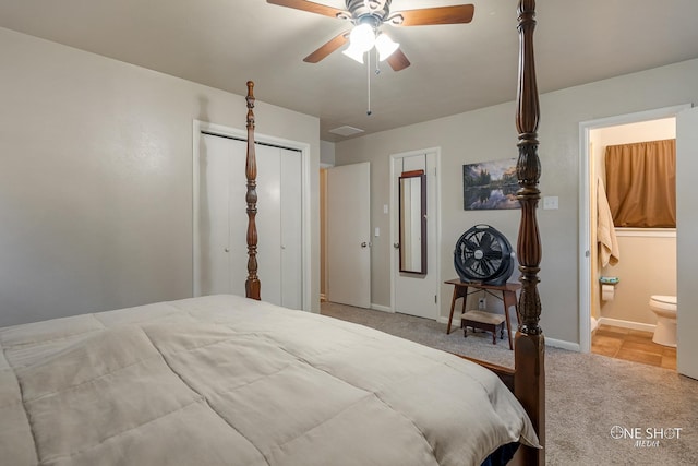 bedroom with connected bathroom, ceiling fan, a closet, and light colored carpet