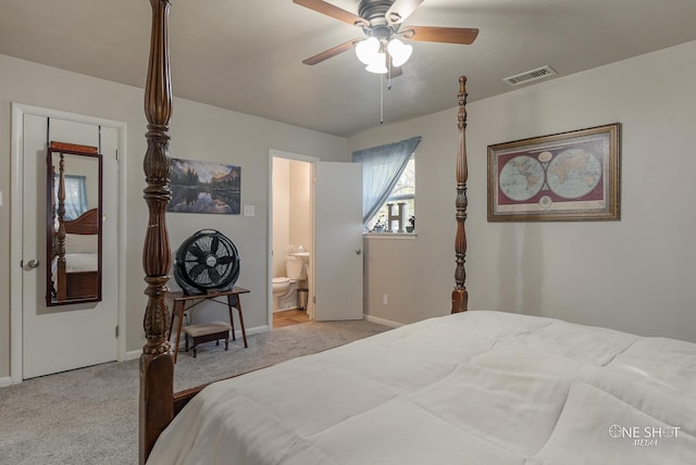 bedroom with ceiling fan, light carpet, and ensuite bath