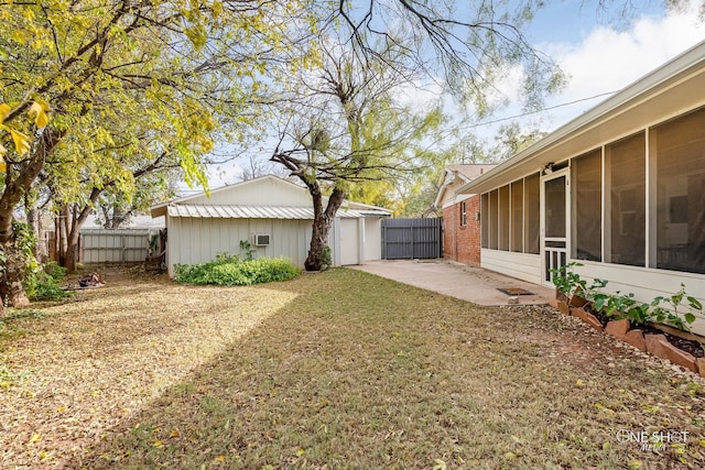 view of yard featuring a sunroom and a patio