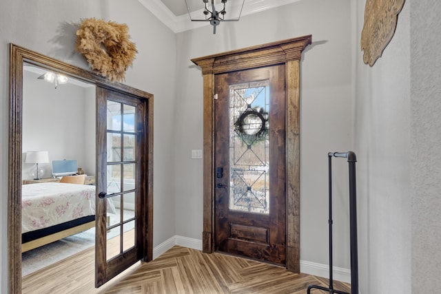 foyer with light parquet flooring, plenty of natural light, and ornamental molding