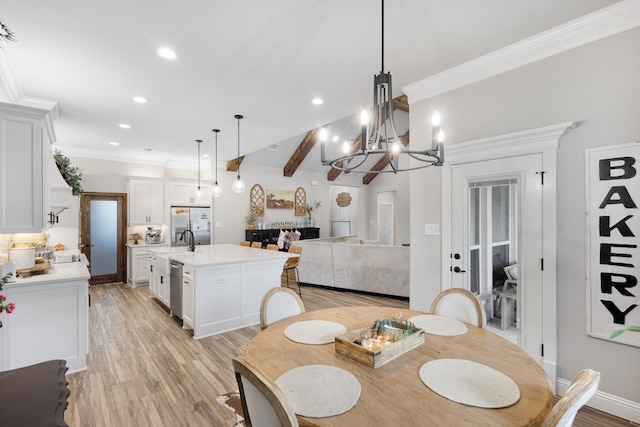 dining area featuring ornamental molding, sink, light hardwood / wood-style flooring, beamed ceiling, and a chandelier