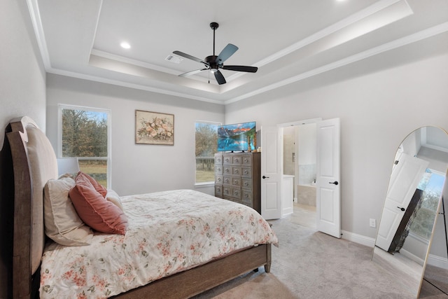 bedroom featuring connected bathroom, ceiling fan, crown molding, light colored carpet, and a tray ceiling