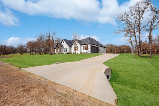 view of front facade featuring an attached garage, a front lawn, and concrete driveway