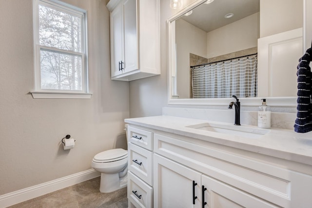 bathroom featuring walk in shower, vanity, and toilet