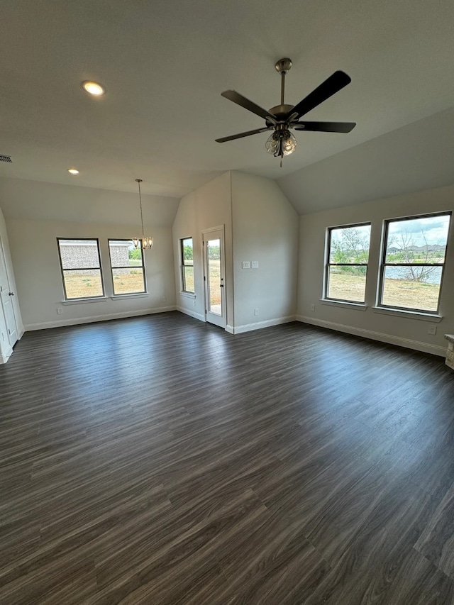 unfurnished room featuring ceiling fan with notable chandelier, dark hardwood / wood-style flooring, and lofted ceiling