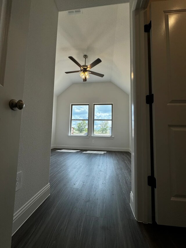 bonus room with dark hardwood / wood-style flooring, vaulted ceiling, and ceiling fan