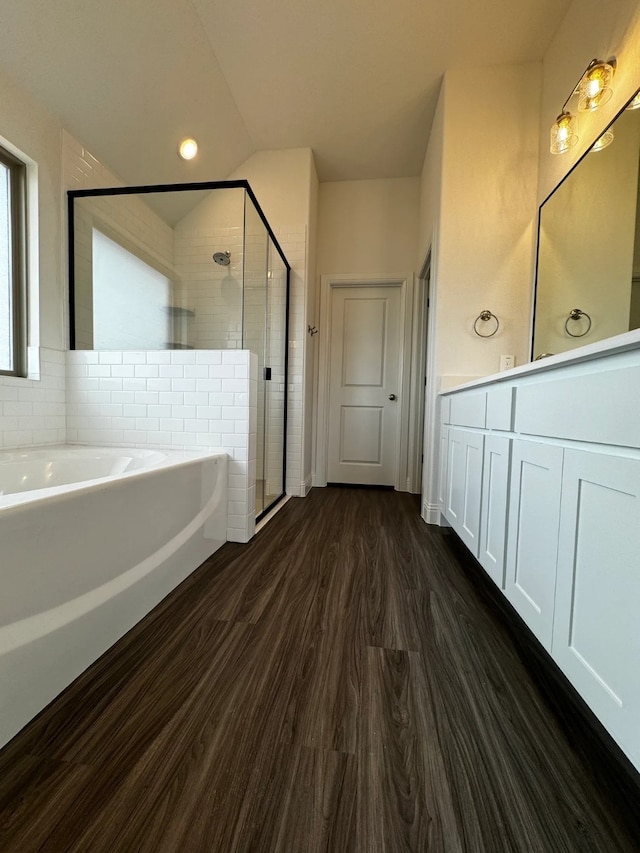 bathroom featuring vanity, shower with separate bathtub, and hardwood / wood-style flooring