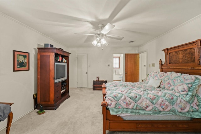 bedroom with ensuite bath, ceiling fan, light carpet, and ornamental molding