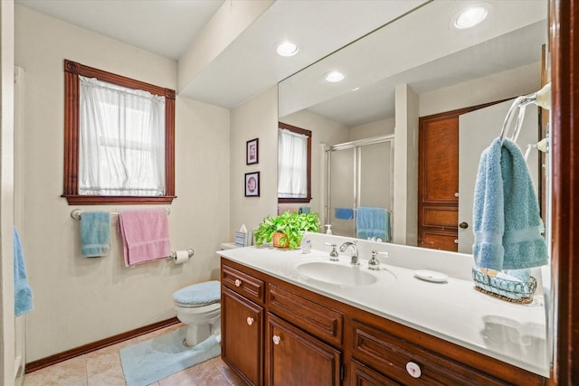 bathroom featuring tile patterned flooring, vanity, toilet, and a shower with door