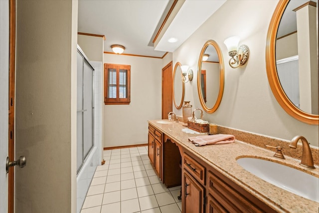 bathroom featuring tile patterned flooring, vanity, crown molding, and bath / shower combo with glass door