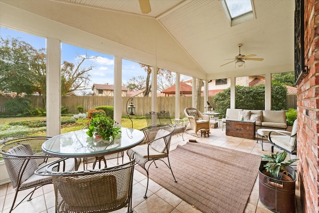 sunroom featuring ceiling fan and lofted ceiling