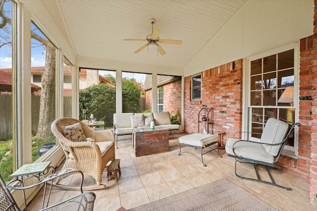 sunroom featuring ceiling fan and lofted ceiling