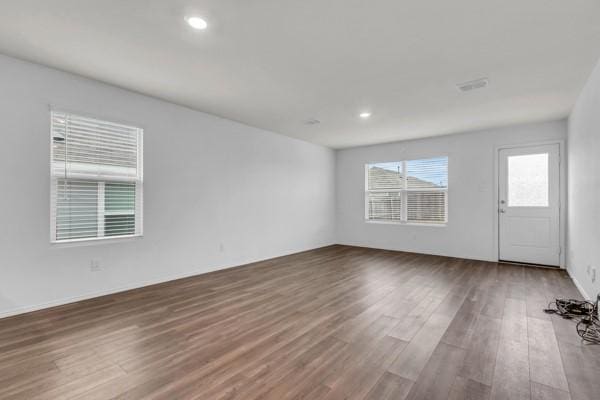 unfurnished room featuring dark wood-type flooring