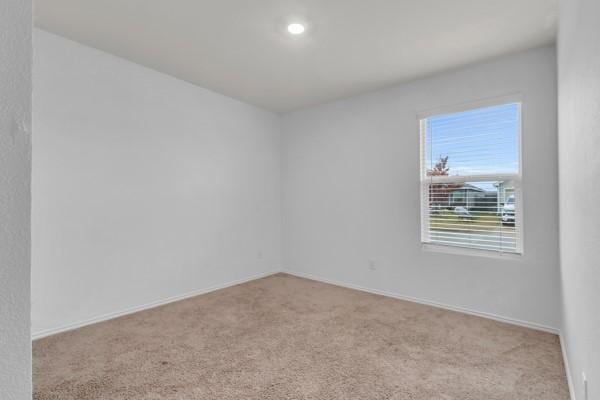 unfurnished room with light colored carpet