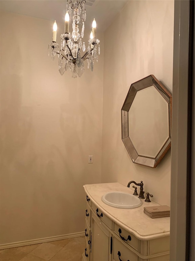 bathroom featuring tile patterned flooring, vanity, and a notable chandelier