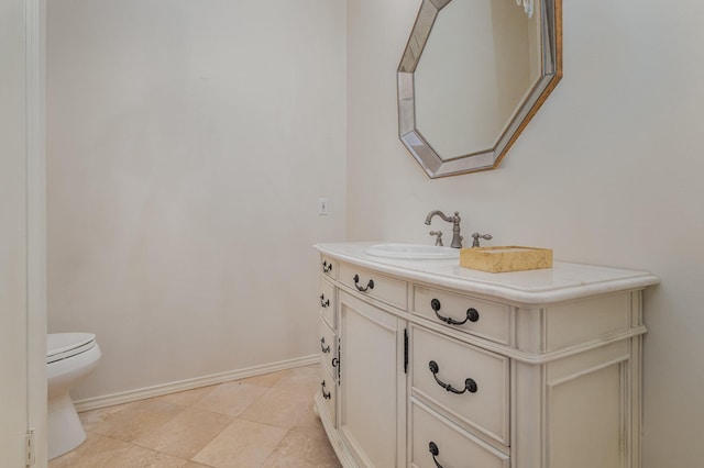 bathroom featuring toilet, vanity, and tile patterned flooring