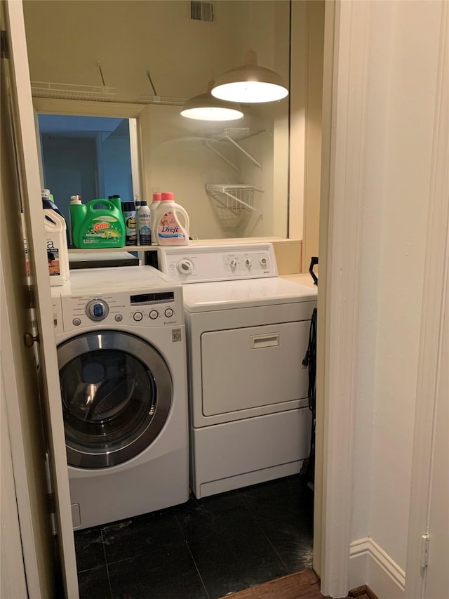 clothes washing area with washer and dryer