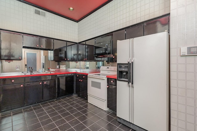 kitchen featuring sink, tile walls, dark tile patterned floors, and black appliances