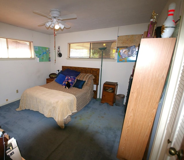 bedroom with carpet, ceiling fan, and multiple windows