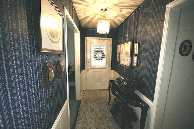 entryway with a chandelier