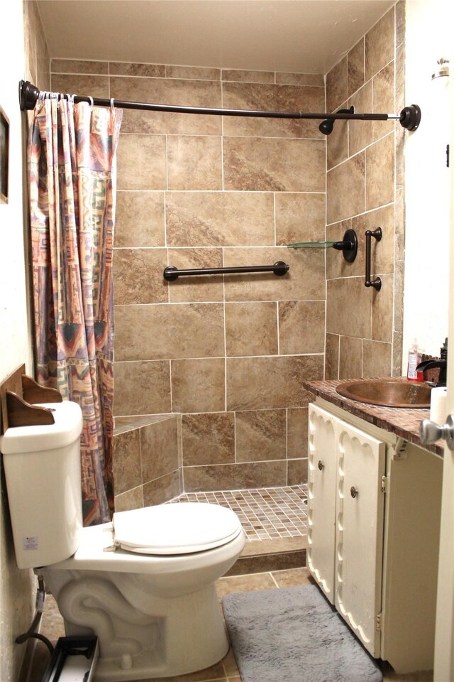 bathroom featuring tile patterned floors, vanity, toilet, and curtained shower