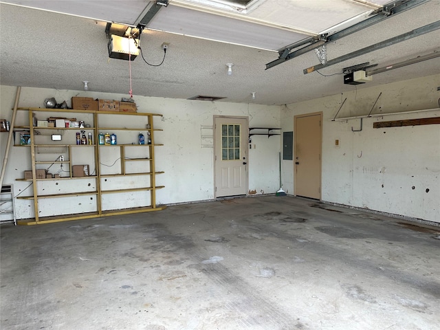 garage featuring electric panel and a garage door opener