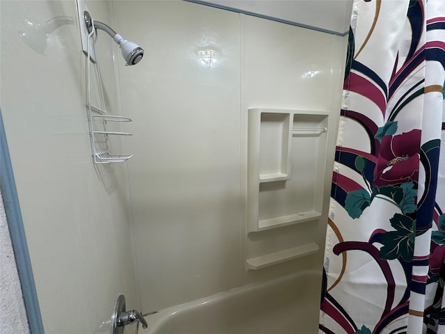 bathroom with shower / bathtub combination with curtain